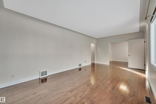Empty room with light wood-style floors and baseboards - 6803 112A Street, Edmonton, AB - Indoor Photo Showing Other Room