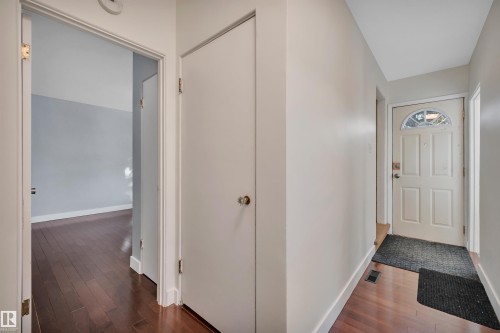 Foyer entrance featuring dark wood-style floors and baseboards - 6803 112A Street, Edmonton, AB - Indoor Photo Showing Other Room