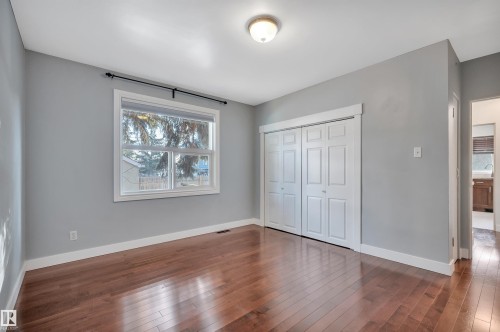 Unfurnished bedroom featuring dark wood-type flooring and a closet - 6803 112A Street, Edmonton, AB - Indoor Photo Showing Other Room
