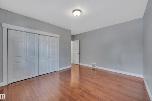 Unfurnished bedroom featuring light wood finished floors and a closet - 6803 112A Street, Edmonton, AB - Indoor Photo Showing Other Room