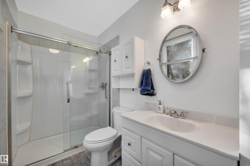 Full bathroom with a shower stall, vanity, and wood finished floors - 6803 112A Street, Edmonton, AB - Indoor Photo Showing Bathroom