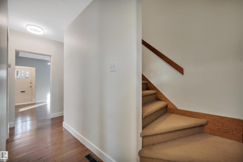 Stairway featuring hardwood / wood-style flooring and baseboards - 6803 112A Street, Edmonton, AB - Indoor Photo Showing Other Room
