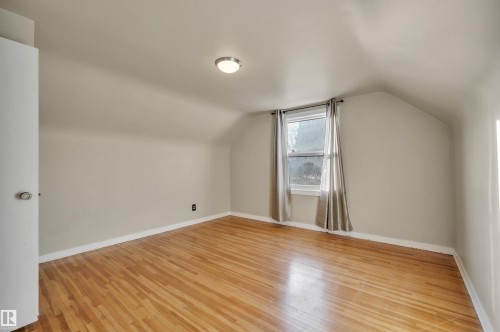 Additional living space featuring light wood-style floors and vaulted ceiling - 6803 112A Street, Edmonton, AB - Indoor Photo Showing Other Room