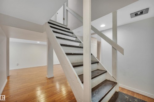 Staircase featuring wood-type flooring and recessed lighting - 6803 112A Street, Edmonton, AB - Indoor Photo Showing Other Room