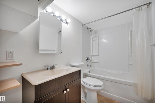 Bathroom featuring shower / tub combo, vanity, and light tile patterned floors - 6803 112A Street, Edmonton, AB - Indoor Photo Showing Bathroom