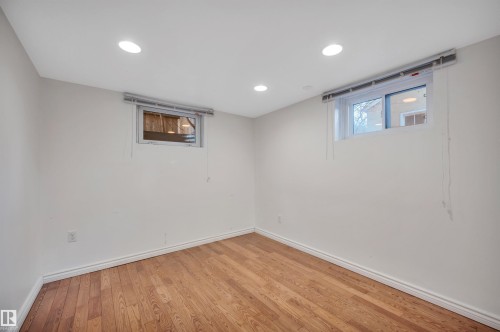 Below grade area with wood finished floors and recessed lighting - 6803 112A Street, Edmonton, AB - Indoor Photo Showing Other Room