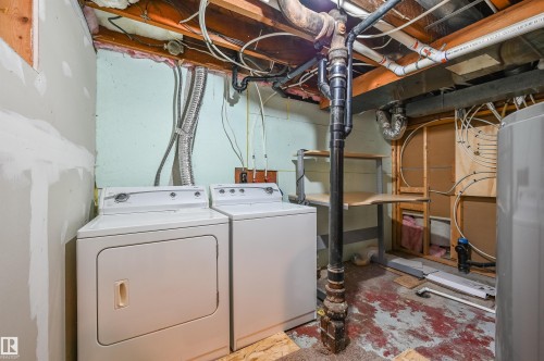 Laundry area with water heater and washer and clothes dryer - 6803 112A Street, Edmonton, AB - Indoor Photo Showing Laundry Room