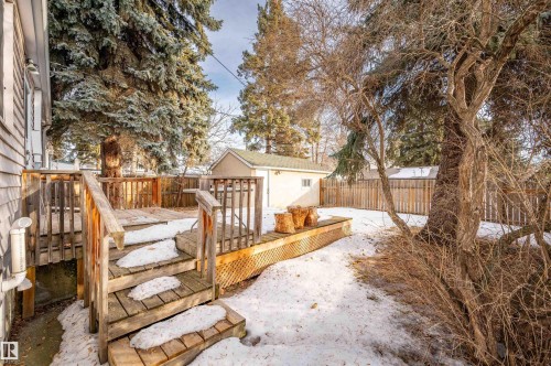 Snow covered deck featuring a fenced backyard and an outdoor structure - 6803 112A Street, Edmonton, AB - Outdoor