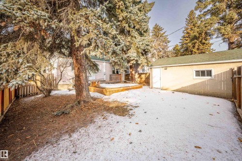 Yard covered in snow featuring a fenced backyard and a deck - 6803 112A Street, Edmonton, AB - Outdoor