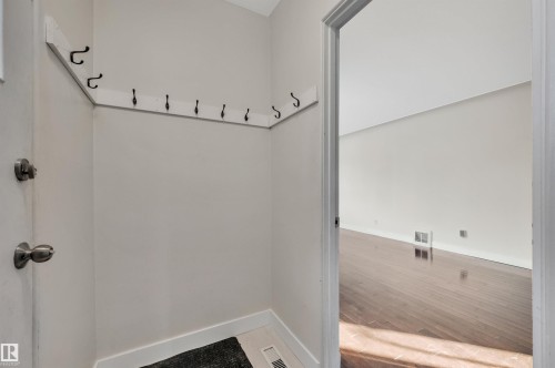 Mudroom featuring hardwood / wood-style flooring and baseboards - 6803 112A Street, Edmonton, AB - Indoor Photo Showing Other Room
