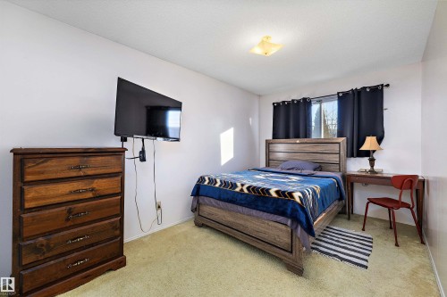 Bedroom with carpet flooring and baseboards - 12117 91 Street, Edmonton, AB - Indoor Photo Showing Bedroom