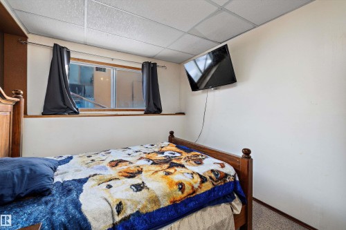 Carpeted bedroom featuring a paneled ceiling and baseboards - 12117 91 Street, Edmonton, AB - Indoor Photo Showing Bedroom