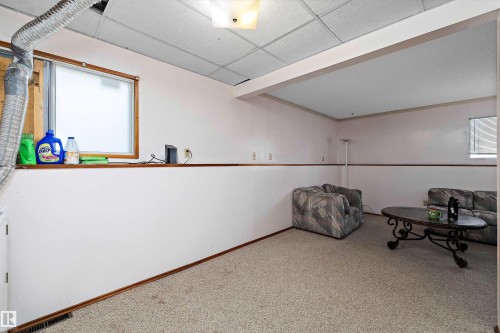 Unfurnished room featuring carpet flooring, a paneled ceiling, and plenty of natural light - 12117 91 Street, Edmonton, AB - Indoor Photo Showing Other Room