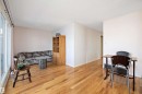Living area featuring light wood-type flooring and a textured ceiling - 12117 91 Street, Edmonton, AB  - Indoor 
