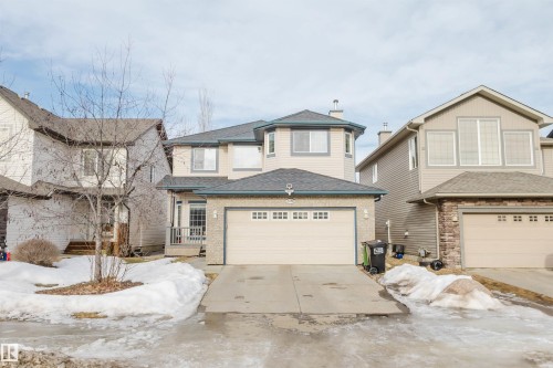 View of front facade with driveway, a shingled roof, and an attached garage - 8420 Sloane Crescent, Edmonton, AB - Outdoor With Facade
