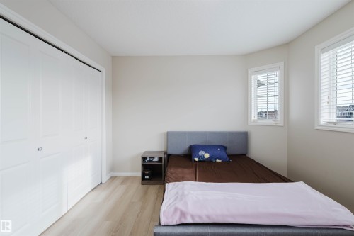 Bedroom with wood finished floors and a closet - 8420 Sloane Crescent, Edmonton, AB - Indoor Photo Showing Bedroom