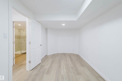 Empty room featuring light wood finished floors and recessed lighting - 8420 Sloane Crescent, Edmonton, AB - Indoor Photo Showing Other Room