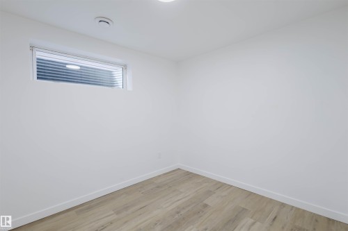 Unfurnished room with baseboards and wood finished floors - 8420 Sloane Crescent, Edmonton, AB - Indoor Photo Showing Other Room