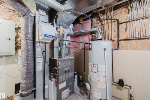 Utilities featuring electric panel, heating unit, and gas water heater - 8420 Sloane Crescent, Edmonton, AB - Indoor Photo Showing Basement
