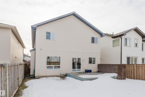 Snow covered rear of property with a fenced backyard and a deck - 8420 Sloane Crescent, Edmonton, AB - Outdoor With Exterior