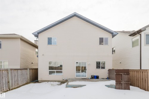 Snow covered rear of property with a fenced backyard and a patio - 8420 Sloane Crescent, Edmonton, AB - Outdoor With Exterior
