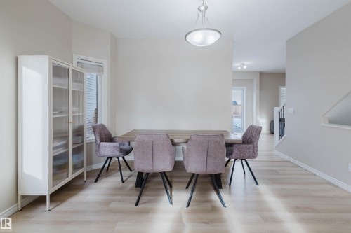 Dining space featuring light wood-style flooring - 8420 Sloane Crescent, Edmonton, AB - Indoor Photo Showing Other Room