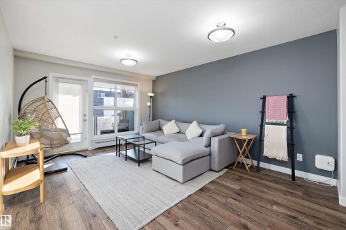 Living area featuring wood finished floors and a baseboard radiator - 205 8515 99 Street, Edmonton, AB - Indoor Photo Showing Other Room