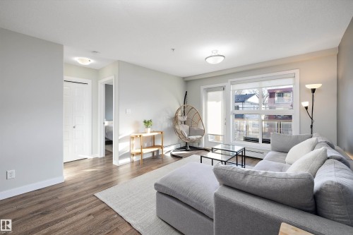 Living area with wood finished floors and baseboards - 205 8515 99 Street, Edmonton, AB - Indoor Photo Showing Living Room