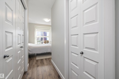 Hallway featuring baseboards and dark wood finished floors - 205 8515 99 Street, Edmonton, AB - Indoor Photo Showing Other Room