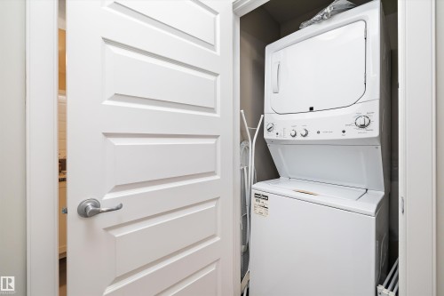 Laundry area featuring stacked washer and dryer - 205 8515 99 Street, Edmonton, AB - Indoor Photo Showing Laundry Room