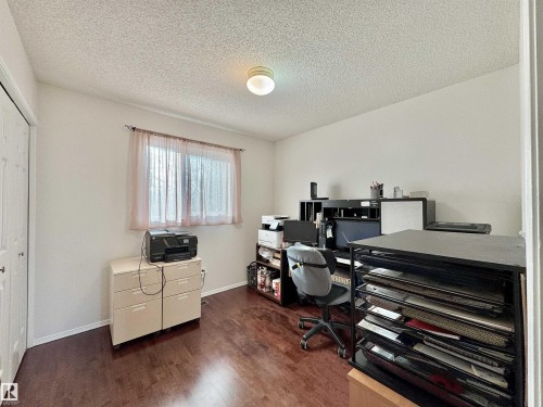 Office area with dark wood-style flooring and a textured ceiling - 3772 30 Street, Edmonton, AB - Indoor Photo Showing Office