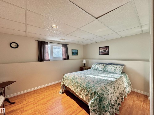 Bedroom with a drop ceiling and light wood finished floors - 3772 30 Street, Edmonton, AB - Indoor Photo Showing Bedroom