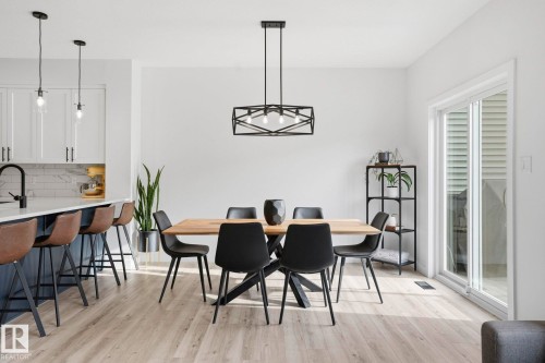 Dining area with light wood-style flooring - 16627 31 Avenue, Edmonton, AB - Indoor Photo Showing Dining Room