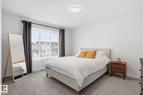 Bedroom featuring baseboards and light colored carpet - 16627 31 Avenue, Edmonton, AB - Indoor Photo Showing Bedroom