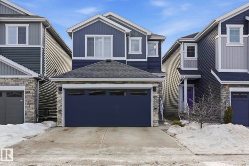 Craftsman inspired home featuring stone siding, roof with shingles, concrete driveway, and a garage - 16627 31 Avenue, Edmonton, AB - Outdoor With Facade