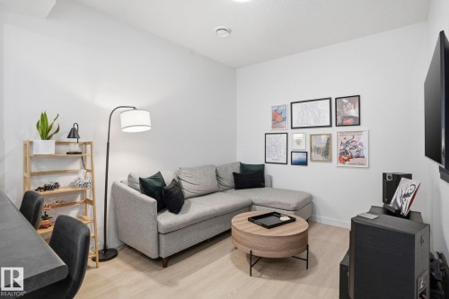 Living room featuring light wood-style flooring and baseboards - 16627 31 Avenue, Edmonton, AB - Indoor