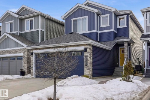 Craftsman inspired home featuring stone siding and board and batten siding - 16627 31 Avenue, Edmonton, AB - Outdoor