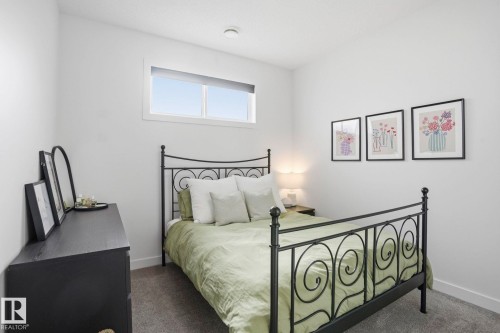 Bedroom featuring dark carpet and baseboards - 16627 31 Avenue, Edmonton, AB - Indoor Photo Showing Bedroom