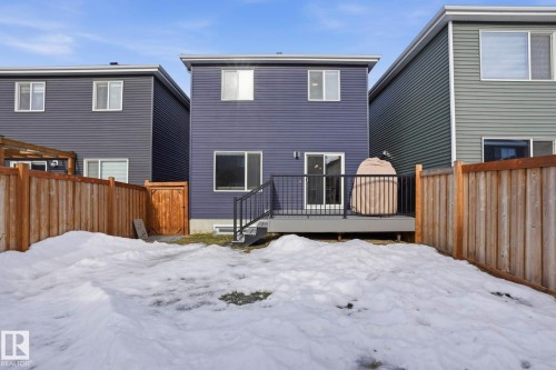 Snow covered property with a fenced backyard and a deck - 16627 31 Avenue, Edmonton, AB - Outdoor With Exterior