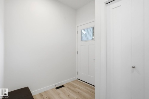 Doorway to outside with baseboards and wood finished floors - 16627 31 Avenue, Edmonton, AB - Indoor Photo Showing Other Room