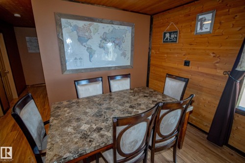 Dining space with wooden walls, wood ceiling, and light wood-style flooring - 56430 Range Rd 113, Rural St. Paul County, AB - Indoor Photo Showing Dining Room
