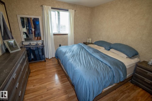 Bedroom with light wood-style flooring - 56430 Range Rd 113, Rural St. Paul County, AB - Indoor Photo Showing Bedroom