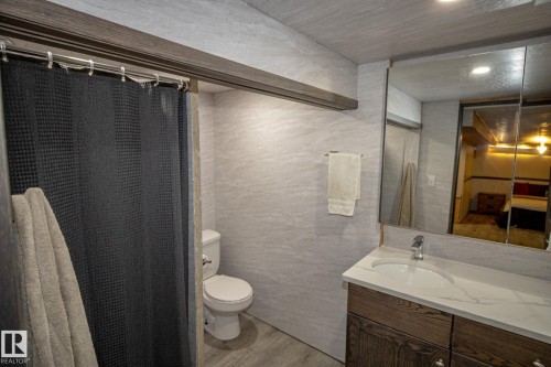 Ensuite bathroom featuring a shower with curtain, vanity, light wood finished floors, and recessed lighting - 56430 Range Rd 113, Rural St. Paul County, AB - Indoor Photo Showing Bathroom