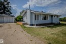 View of property exterior with a patio, an outbuilding, a yard, and a garage - 56430 Range Rd 113, Rural St. Paul County, AB  - Outdoor 