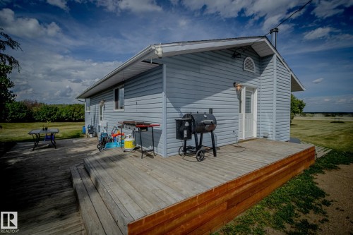 Deck with area for grilling and a lawn - 56430 Range Rd 113, Rural St. Paul County, AB - Outdoor With Deck Patio Veranda