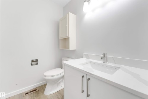 Bathroom featuring vanity and light wood-style flooring - 14511 21 St., Edmonton, AB - Indoor Photo Showing Bathroom