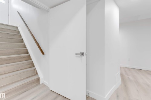 Staircase with wood finished floors - 14511 21 St., Edmonton, AB - Indoor Photo Showing Other Room