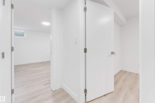 Hallway with light wood-type flooring and baseboards - 14511 21 St., Edmonton, AB - Indoor Photo Showing Other Room