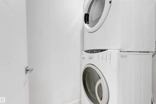 Laundry room featuring stacked washing machine and dryer - 14511 21 St., Edmonton, AB - Indoor Photo Showing Laundry Room
