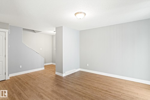 Living room featuring light wood finished floors and a textured ceiling - 914 9 Street, Cold Lake, AB - Indoor Photo Showing Other Room